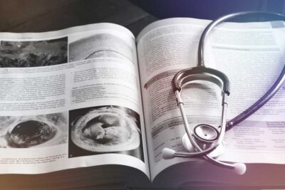 Open medical journal with stethescope